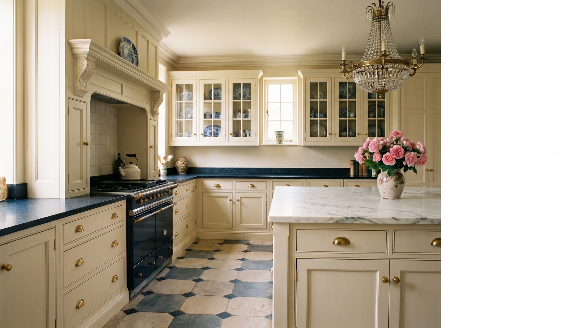 Reeve & Co Essex kitchen hero — cream moulded in-frame cabinetry with carved overmantle, glazed astragal cupboards, marble island