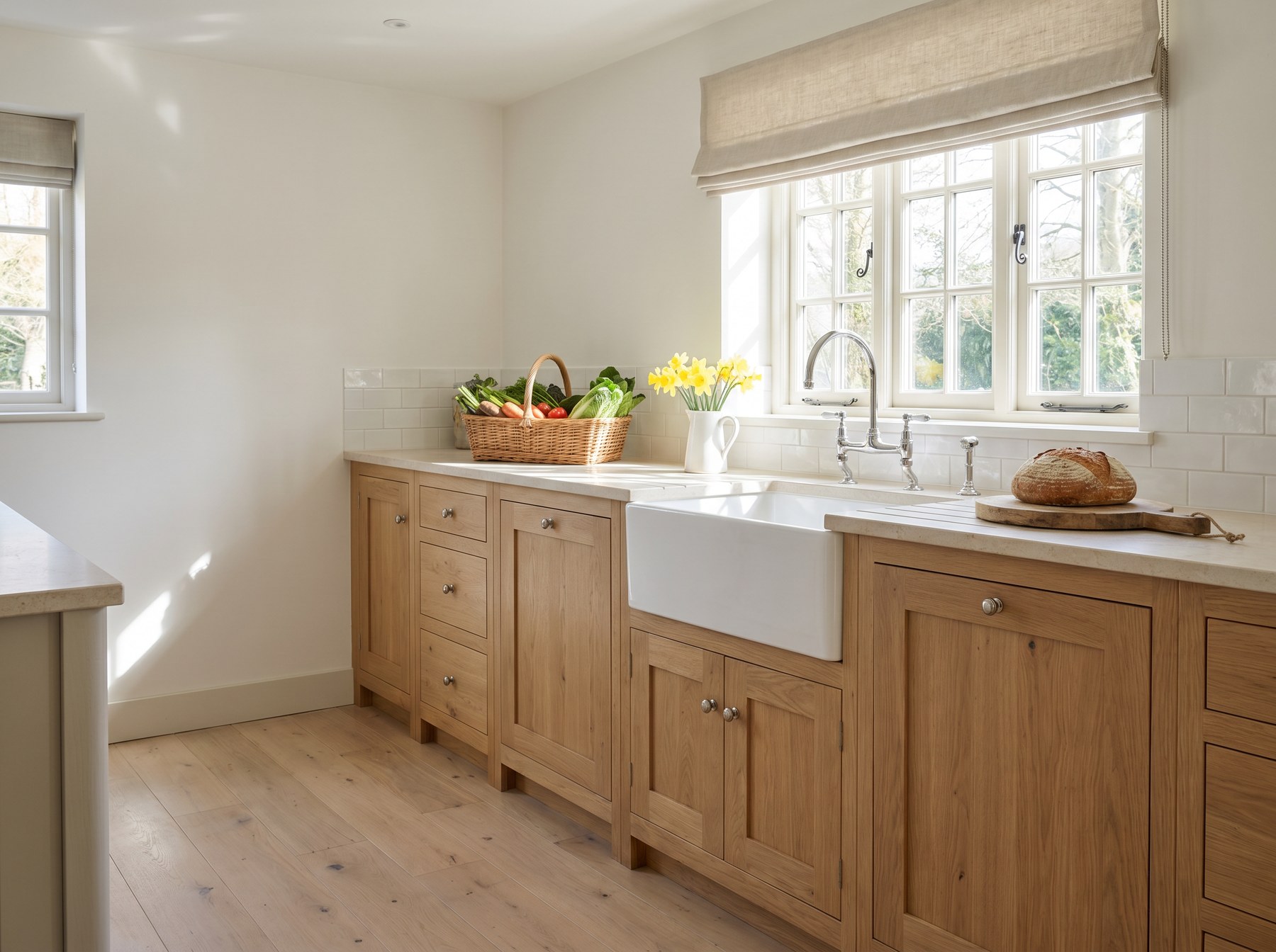 Reeve & Co Shaker kitchen in natural solid oak with oiled finish, classic flat inset panels, honed limestone worktop and white Belfast sink